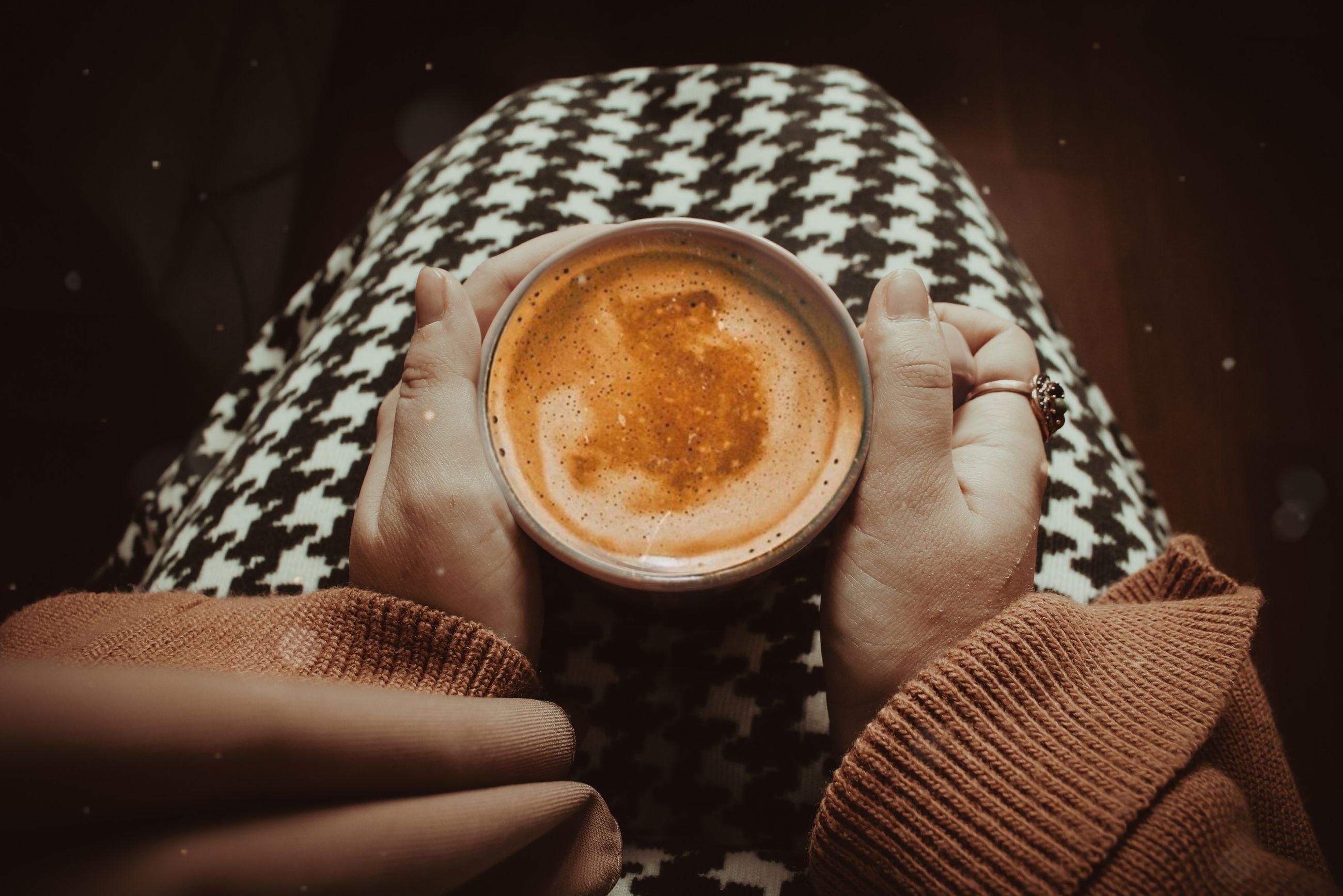 Warm hands around a cup of coffee